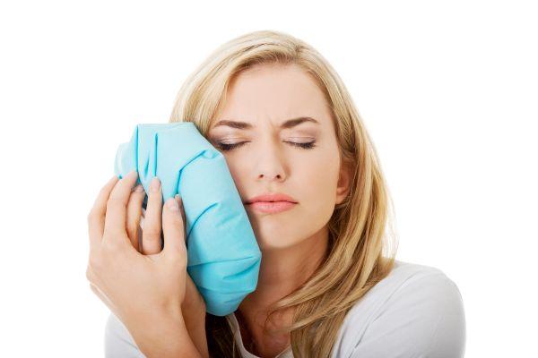 A woman in pain before getting a Tooth extraction Service in Cloverdale, WA