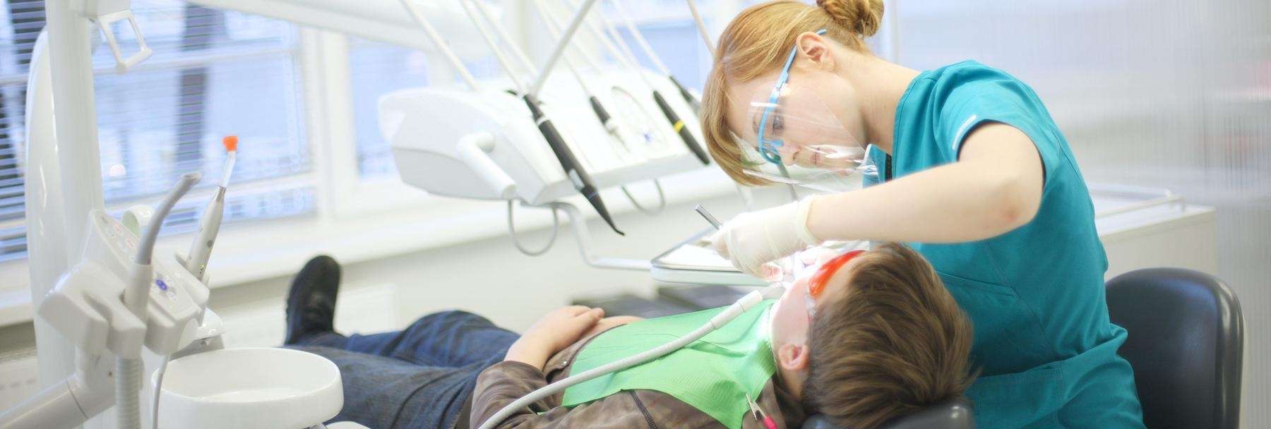 cloverdale dentist cleaning a patient's teeth at Wright Street Dental Clinic